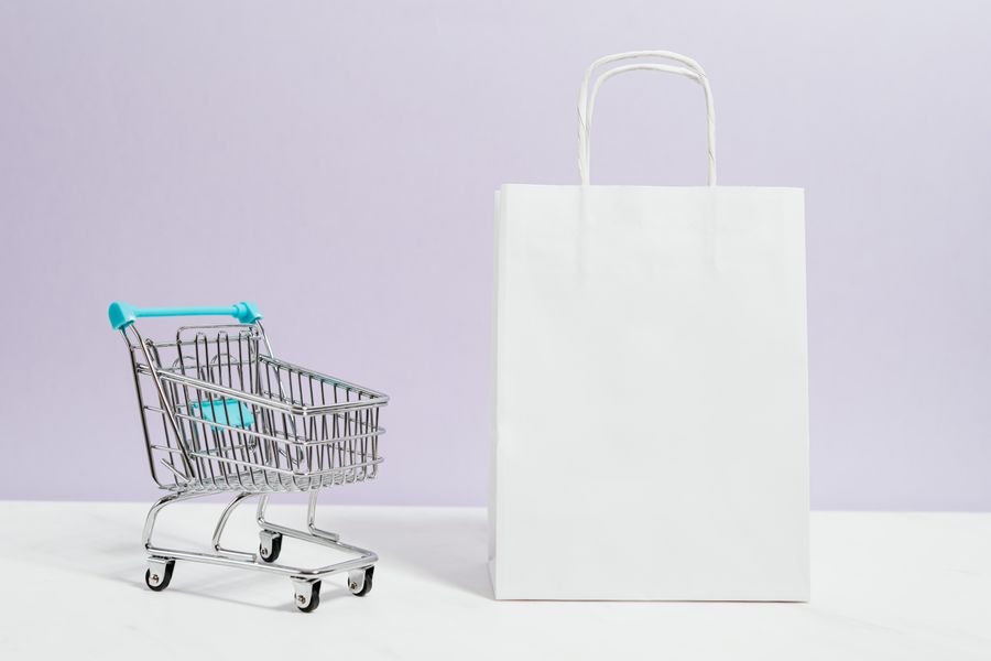 A shopping cart and paper gift bag — e-commerce