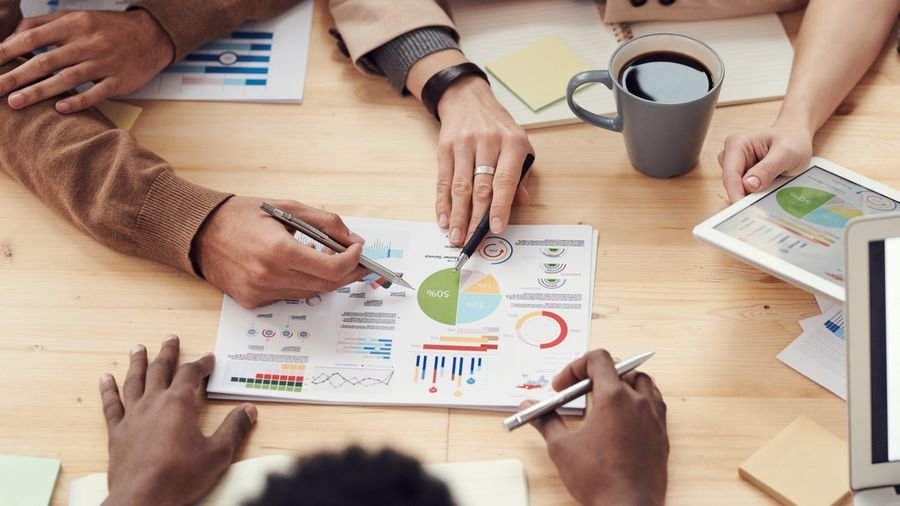 Hands reviewing marketing performance charts on a desk